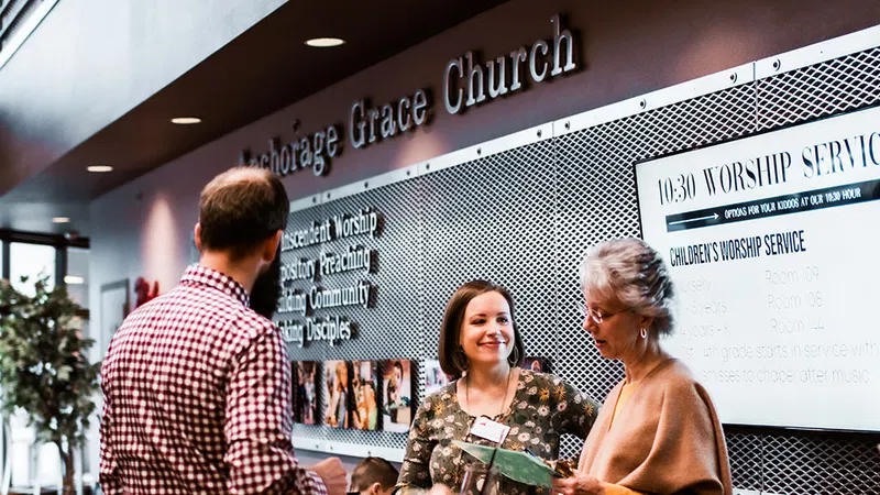 People talking in the church lobby