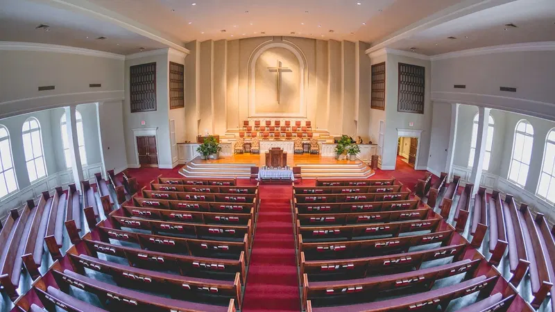 Sanctuary with wooden pews and a central aisle