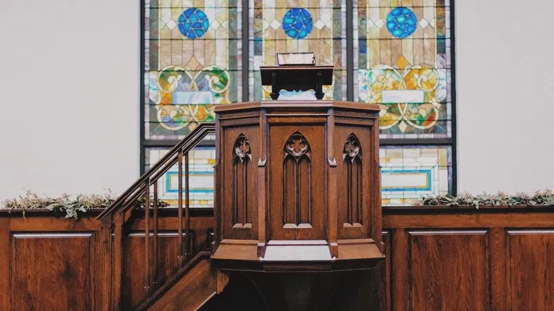 Sanctuary with a wooden pulpit and stained-glass windows